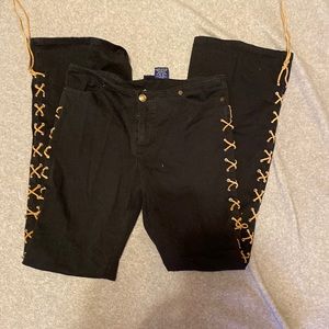 D’Mode pants. Black with leather strings going down the legs and across the back